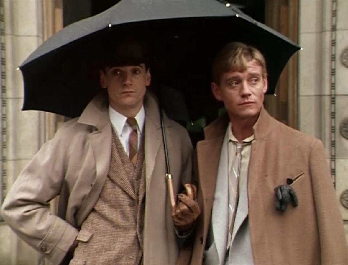 charles and sebastian from brideshead revisited, standing together under an umbrella. they both face the camera but look off in opposite directions, wearing similarly resigned expressions.